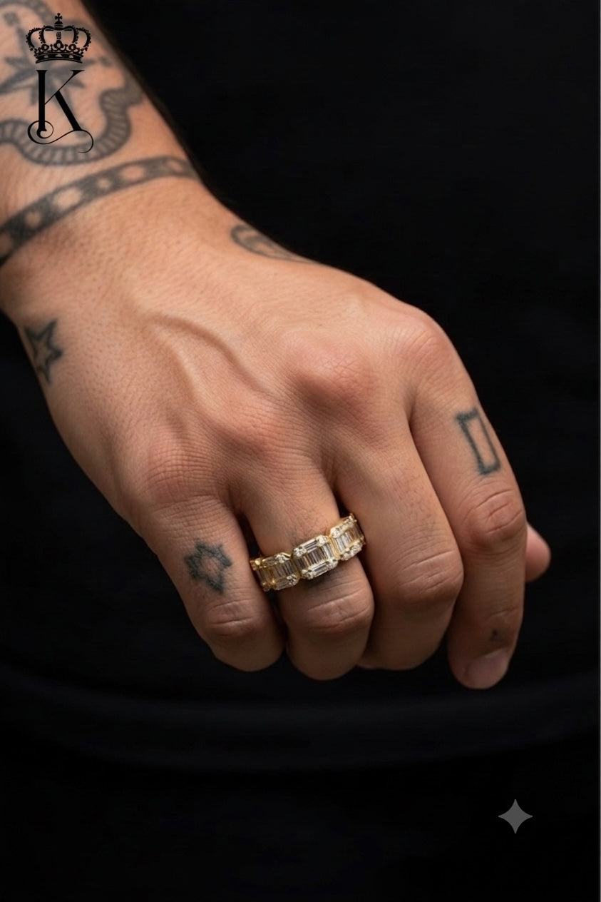 Fantastic Jewelry Department gold baguette eternity band ring worn on a tattooed hand against a black background
