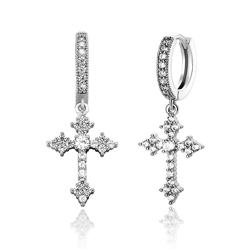Silver cross earrings with clear stones on a white background